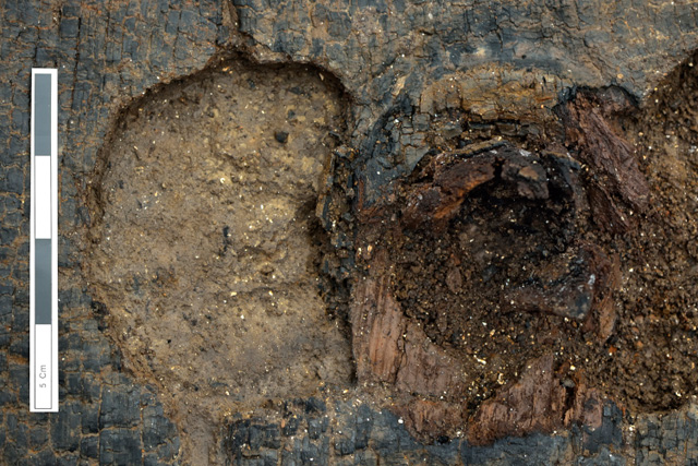 Close-up showing one of the lunate holes next to the axle