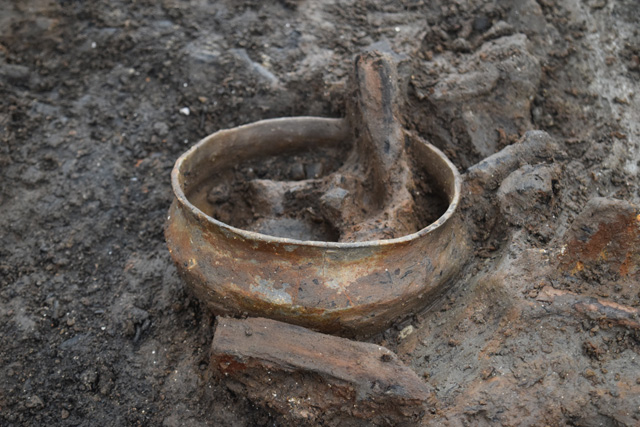 Complete pot found directly underneath the interior of RH 1. Many other complete vessels are appearing in the occupation deposit. 