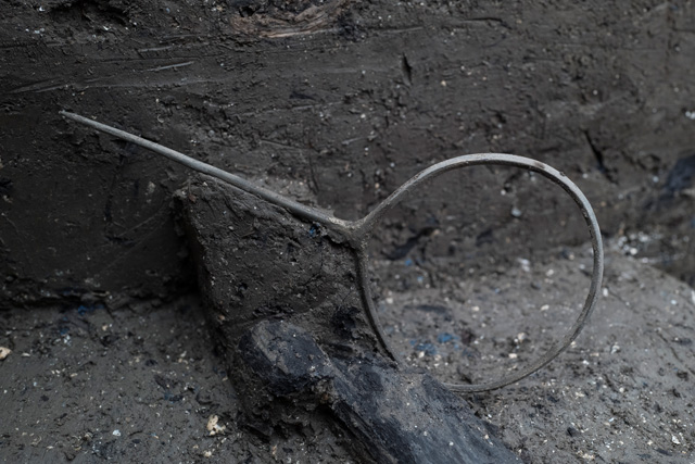 Delicate quoit-headed pin found close to the causeway, not all the metalwork deposited close to the walkway are weapons.